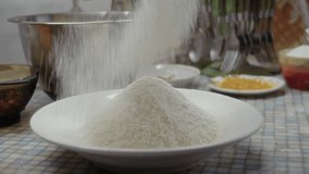 Close-up, sifting flour through a sieve into a plate on the kitchen counter to make a pumpkin cake - Powered by Shutterstock - Get 15% off with code: PIKWIZARD15