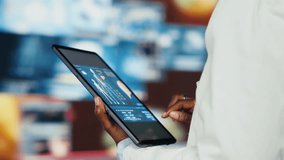 Close up of researcher analyzing human anatomy using tablet app in front of digital health dashboards backdrop. Scientist zooming on touchscreen device display keyboard, analyzing medical scans - Powered by Shutterstock - Get 15% off with code: PIKWIZARD15