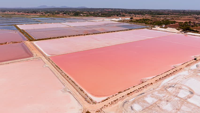 Pink salt evaporation ponds creating a stunning landscape in ses salines d'es trenc, mallorca, spain