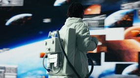 Joyous female astronaut dancing while surrounded by Mars planetary analysis data screens in spacecraft. Happy african american starship crew member having fun while exploring deep space, camera B - Powered by Shutterstock - Get 15% off with code: PIKWIZARD15