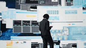 Business specialist using tablet to review performance dashboards metrics during corporate strategy planning session. Management executive evaluating annual report data using device, camera A - Powered by Shutterstock - Get 15% off with code: PIKWIZARD15