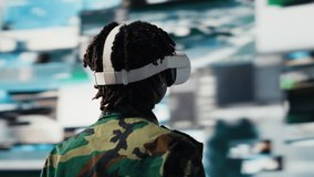 Military operator in war room oversees mission operations using virtual reality technology. Army soldier using VR headset equipment to do surveillance and threat monitoring, camera B - Powered by Shutterstock - Get 15% off with code: PIKWIZARD15