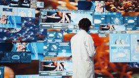 Cheerful woman showing futuristic medical visuals on digital videowall during conference. Jolly African american doctor presenting medical research data and 3D anatomy models dashboards, camera A - Powered by Shutterstock - Get 15% off with code: PIKWIZARD15