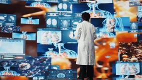 Smiling scientist doing key note presentation with xray scans on digital videowall. Jolly woman sharing latest neurology research innovations to audience, showcasing pictures of human organs, camera A - Powered by Shutterstock - Get 15% off with code: PIKWIZARD15