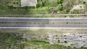Top-down drone footage of traffic on a rural highway. Motorbikes and scooters riding on a multi-lane road in the countryside. Vertical video. - Powered by Shutterstock - Get 15% off with code: PIKWIZARD15