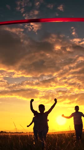 Winner boy. Children boy girl, run red finish line, lawn, silhouette. Group children running toward finish line, victory, success. Active kids run. Athletic child champion. Children race, park lawn