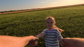 Girl kid holds her father's hand, father daughter spin together on lawn. Dad daughter play on grass in park, holding hands. Happy family. Father child daughter have fun in meadow, first-person view. - Powered by Shutterstock - Get 15% off with code: PIKWIZARD15