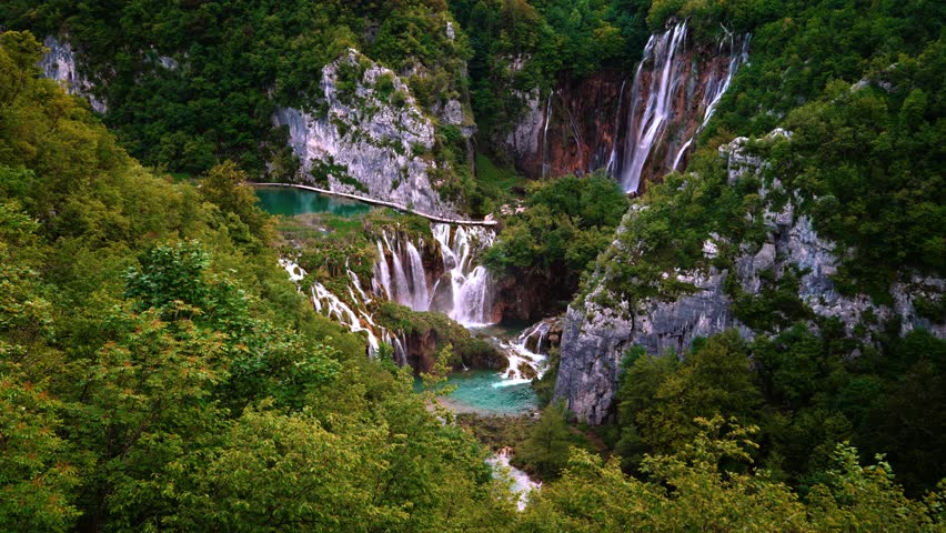 Cascading waterfalls and turquoise pools surrounded by nature. Plitvice Lakes National Park, Croatia