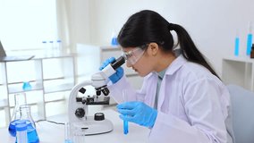 Teen girl adjusting microscope during laboratory experiment. Science, laboratory, scientist, experiment, and research show a student engaging in biology or chemistry with concentration and skill. - Powered by Shutterstock - Get 15% off with code: PIKWIZARD15