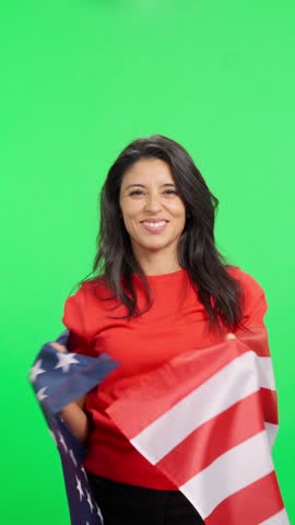 Patriotic american woman waving a United States flag on green screen