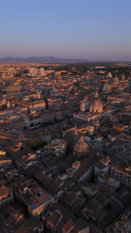 Breathtaking aerial footage meticulously capturing the stunning beauty of a historic Rome during a magnificent sunset, showcasing picturesque rooftops and notable landmarks, Piazza Navona, Rome, Italy