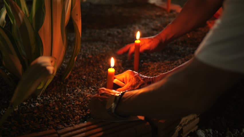 People Worshiping and Placing Burning Candles in Thai Temple, Traditional Buddhist Ceremony Scene