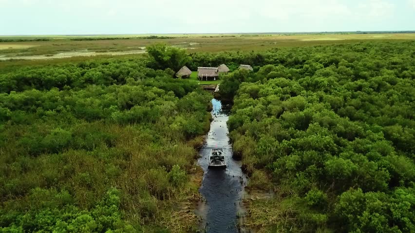 4K Drone Footage of an Airboat on the Water at Sunrise in Everglades National Park on the Miccosukee Reservation, Florida, USA
