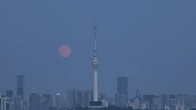 Stunning timelapse footage of full moon rising over Kuala Lumpur skyline with iconic KL Tower at twilight, capturing the city's dramatic urban landscape during autumn evening. - Powered by Shutterstock - Get 15% off with code: PIKWIZARD15