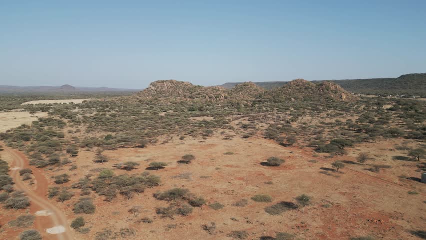 aerial view, African landscape typical Southern African region ,mountain range, savannah bush with acacia trees, shrubs and sand
