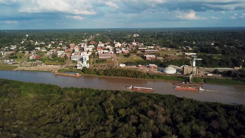 4K Drone Footage of Barges Entering the Port of Greenville on the Mississippi River with the City in the Background, Mississippi, USA