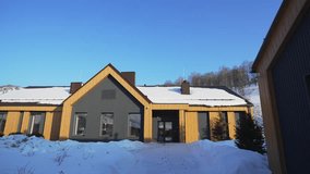 Long wooden cabin lies peacefully amid snow and tender pines. Minimalist design merges cozy mountain living with elegant tradition - Powered by Shutterstock - Get 15% off with code: PIKWIZARD15