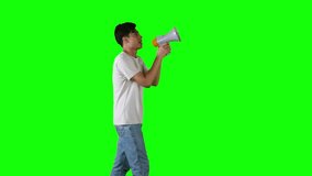 Side View of Young Man Speaking Through Megaphone on Green Screen - Powered by Shutterstock - Get 15% off with code: PIKWIZARD15