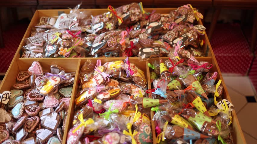Colorful handmade gingerbread cookies wrapped in clear bags with ribbons displayed in wooden boxes festive sweet assortment of traditional european pastry and edible gift collection