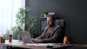 Overworked tired businessman feeling sleepy and yawning while working on a laptop at his desk - Powered by Shutterstock - Get 15% off with code: PIKWIZARD15