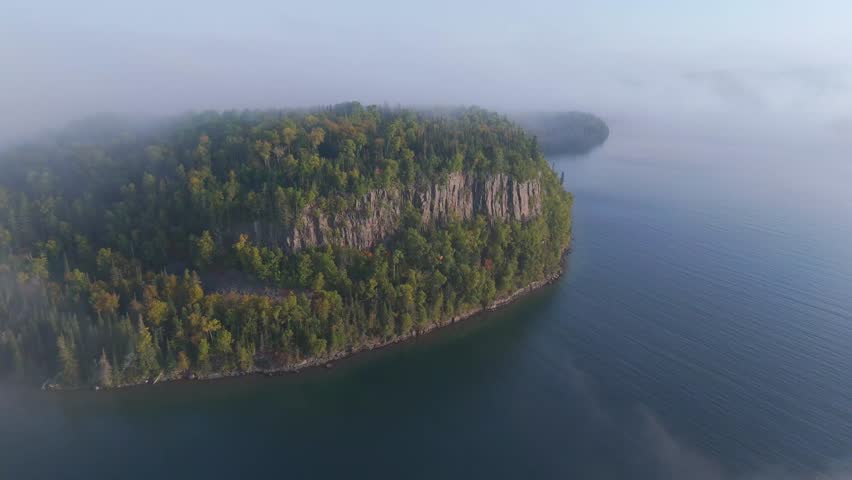 Aerial view Vertical cliff and forest during early autumn at Lake Superior shoreline in Ontario, Canada.