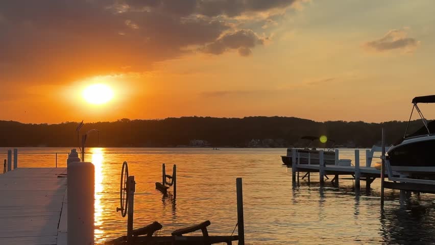Peaceful Lake Geneva sunset with docks and boats, tranquil and scenic
