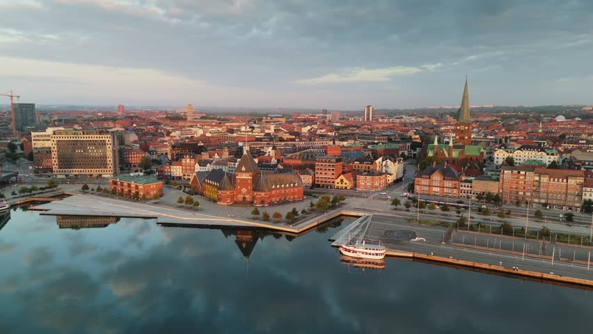 Morning aerial shot of Aarhus old town, Denmark. Skyline of Aarhus with its beautiful buildings and serene waterfront during the golden hour of sunrise