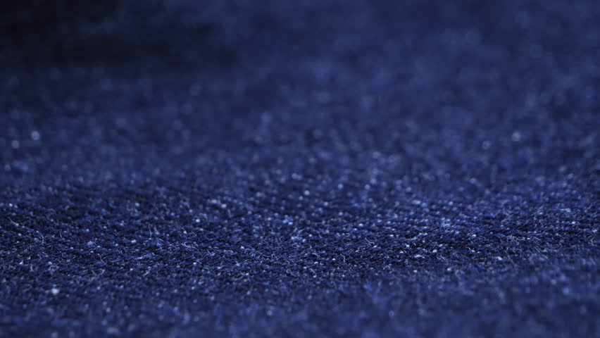 Close up of blue textile jeans texture. Cotton casual clothes. Denim jeans. High quality 4k footage