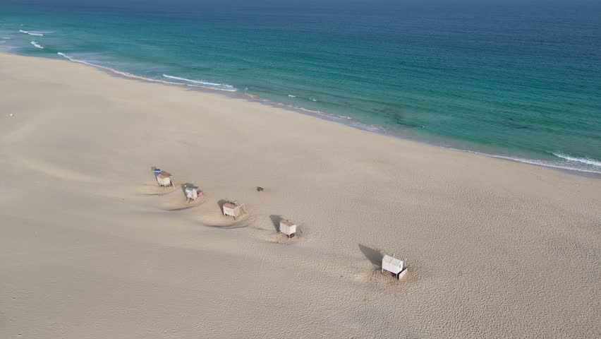 Drone view of Chaves beach at sunny day, sandy beach, turquoise ocean and luxury resort,summer concept, Boa Vista, Cape Verde.