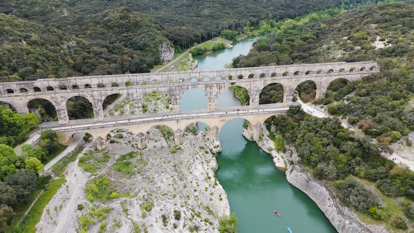 Stunning drone flight towards the ancient Pont du Gard, revealing its timeless beauty from above