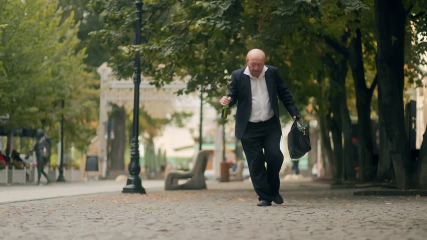 An elderly bald office worker staggers through the city after work, drunk and holding a bottle, representing alcohol abuse, social issues, and the struggles of addiction.