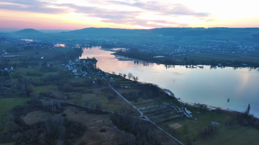 Village near the river Rhine at dusk under an evening cloudy sky
