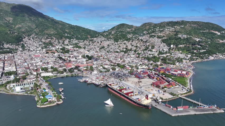 Aerial drone view of Cap-Haïtien, historic city, port, and beautiful bay with mountains in background. Haiti