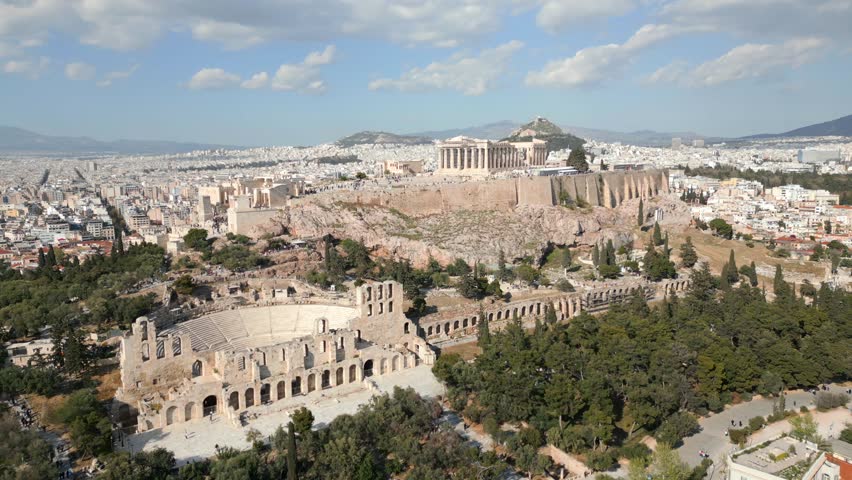 Aerial view of the Parthenon and Acropolis hill in Athens, Greece. Panoramic view of ancient ruins, historic architecture, and the cityscape on sunny day.