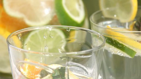 Close up of jug with fresh lemonade pouring to glass. Stockvideó