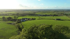 Aerial view of lush green fields interspersed with farmhouses and barns, creating a patchwork of textures and tones under a clear blue sky, Melton Mowbray, England, United Kingdom. - Powered by Shutterstock - Get 15% off with code: PIKWIZARD15