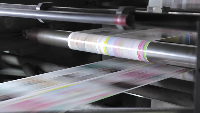 Industrial typography with magazines on conveyor belts in printing press