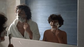 Father and 11-year-old teenage son play shaving with shaving foam and razor in the morning in the bathroom at home - father and son relationship and teaching the child the rules of personal hygiene - Powered by Shutterstock - Get 15% off with code: PIKWIZARD15