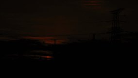 Dramatic time lapse sunrise over Gobi Desert with power transmission tower silhouetted against golden sky and expansive desert landscape - Powered by Shutterstock - Get 15% off with code: PIKWIZARD15