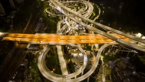 Aerial night view of illuminated highway overpass interchange in Guiyang with golden traffic light trails from time lapse photography, showing complex road infrastructure. - Powered by Shutterstock - Get 15% off with code: PIKWIZARD15