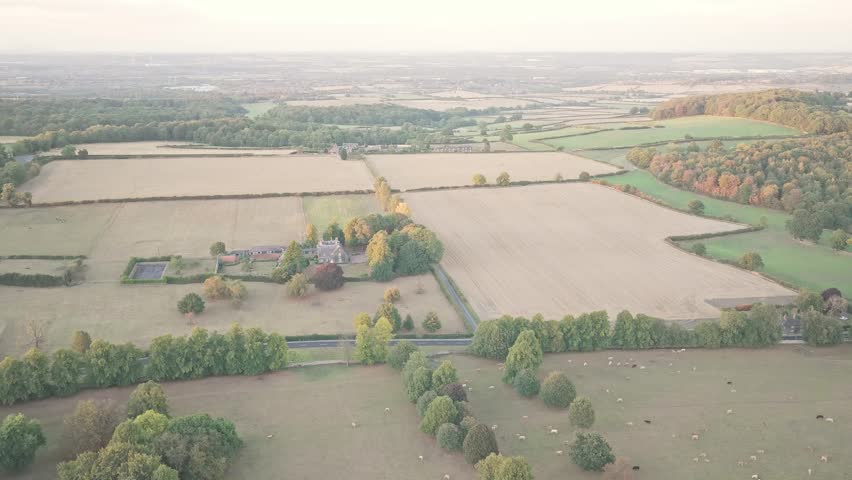 Wentworth’s countryside reveals grazing sheep, divided fields, and tree-lined roads, with estate rooftops nestled among forest patches and rolling farmland drone shot