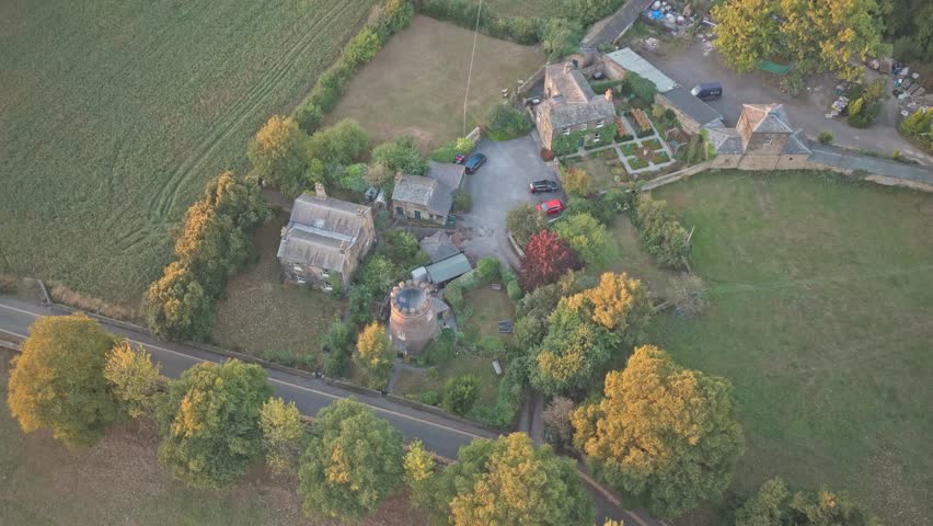 Drone top-down drone reveals Wentworth’s estate vegetable gardens, hedgerows, and tree-lined fields, with historic rooftops and cultivated plots glowing in South Yorkshire’s autumn haze.