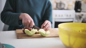 Teenager slicing apples, preparing fruit ingredients for homemade apple-pumpkin pie. Part of series - Powered by Shutterstock - Get 15% off with code: PIKWIZARD15