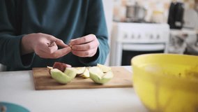 Teenager slicing apples, preparing fruit ingredients for homemade apple-pumpkin pie. Part of series - Powered by Shutterstock - Get 15% off with code: PIKWIZARD15