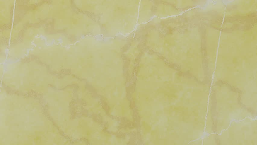 A yellow marble texture with distinct golden veins and a speckled, granular surface. Clear details and vibrant colors enhance visual appeal.