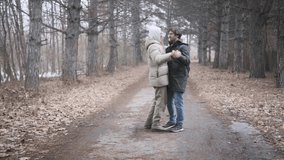 Young joyful couple dancing closely together outdoors in a winter forest on a quiet, romantic day - Powered by Shutterstock - Get 15% off with code: PIKWIZARD15