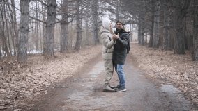 Young joyful couple dancing closely together outdoors in a winter forest on a quiet, romantic day - Powered by Shutterstock - Get 15% off with code: PIKWIZARD15
