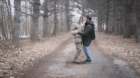 Young joyful couple dancing closely together outdoors in a winter forest on a quiet, romantic day - Powered by Shutterstock - Get 15% off with code: PIKWIZARD15