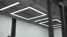 Contemporary office space displaying concrete ceiling and minimalist square led light fixtures, creating a modern, industrial aesthetic - Powered by Shutterstock - Get 15% off with code: PIKWIZARD15