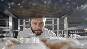 Bearded Caucasian male baker wearing uniform and cap inspecting fresh pastries on baking rack. Floating holographic prices appearing in front of bread and shelves. Modern digital bakery environment. - Powered by Shutterstock - Get 15% off with code: PIKWIZARD15